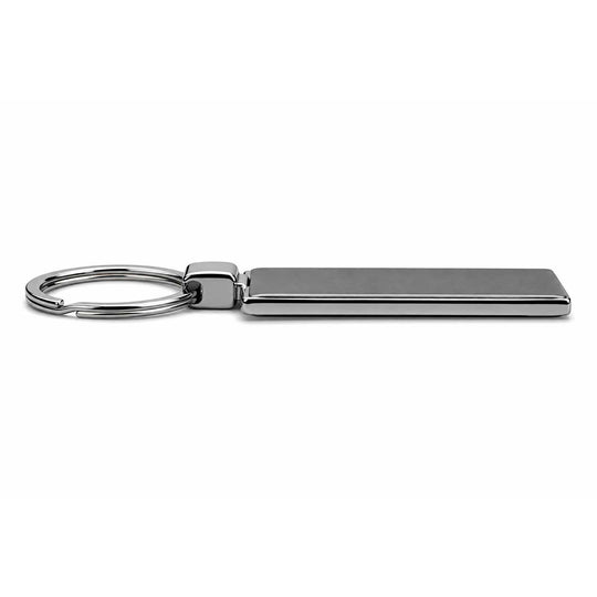 A horizontal keychain featuring the word 'Cummins' in brown raised lettering on a white rectangular base, attached to a silver metal split ring, shown on a plain white background.