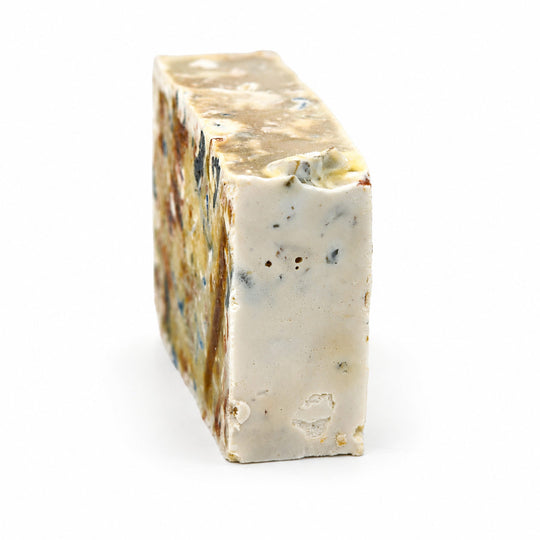 A rectangular bar of handmade soap with a cream-colored base, decorated with embedded brown, blue, and red botanical pieces. The bar features an embossed circular logo and the text 'PRIVATE OAKS' printed on the front, set against a plain white background.