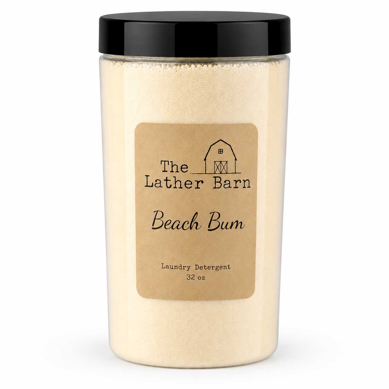 A 32 oz jar of The Lather Barn Beach Bum laundry detergent, featuring a clear container filled with a light beige powder, a tan paper label, and a black screw-on lid, set against a plain white background.
