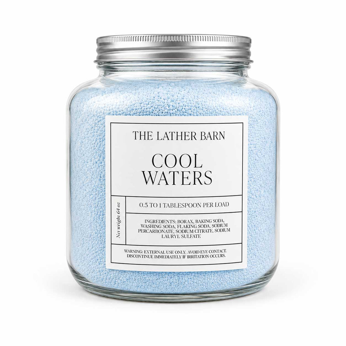 A glass jar filled with light blue bath salts, featuring a white label that reads 'THE LATHER BARN COOL WATERS' and a silver metal lid, set against a plain white background.