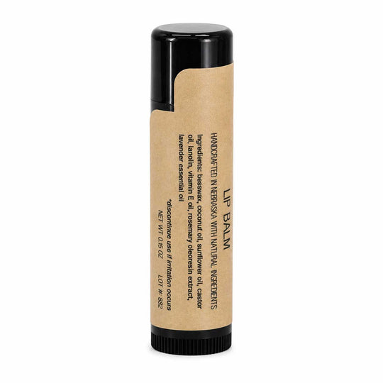 Lip balm with a black cap and brown label on a white background