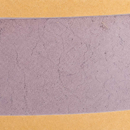 Close-up of a textured purple surface with a gold border