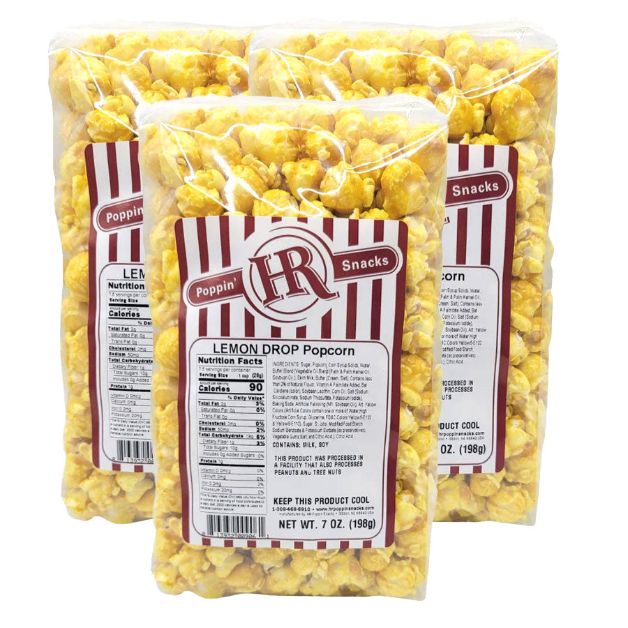 Three packages of lemon drop popcorn with a visible label on a white background