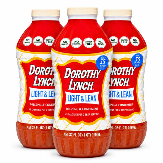Three bottles of Dorothy Lynch Light & Lean dressing and condiment arranged in a triangular formation on a white background.