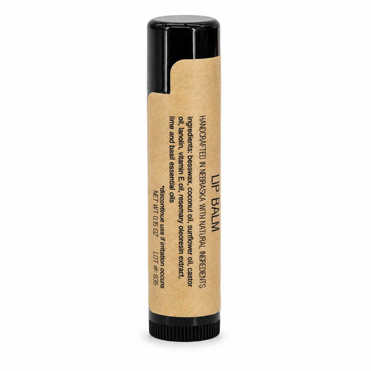 Lip balm with a black cap and kraft paper packaging on a white background
