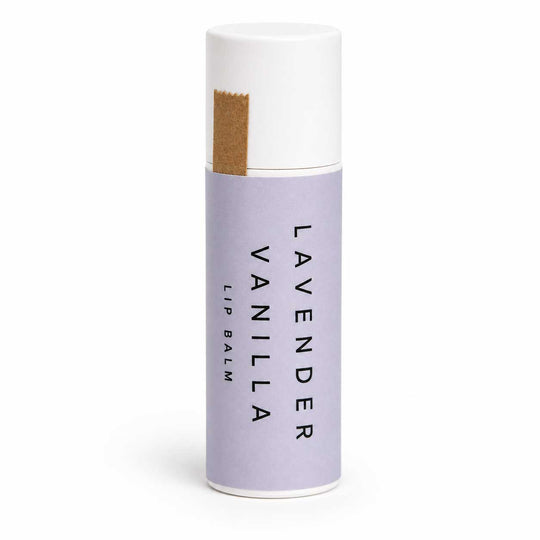 Lavender Vanilla lip balm in a white and purple container on a white background