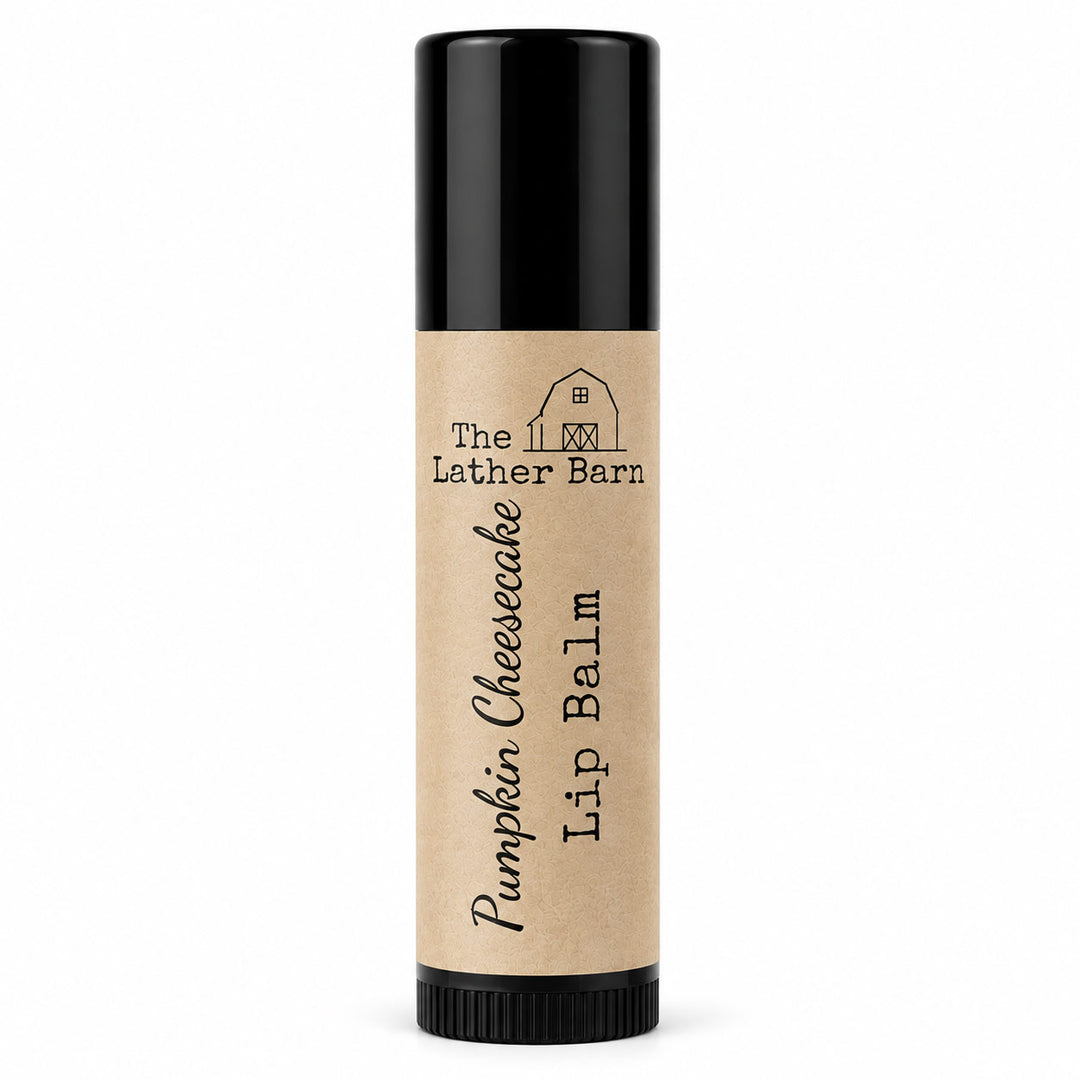 A single tube of lip balm with a kraft paper label reading 'The Lether Barn Pumpkin Cheesecake Lip Balm' on a plain white background.