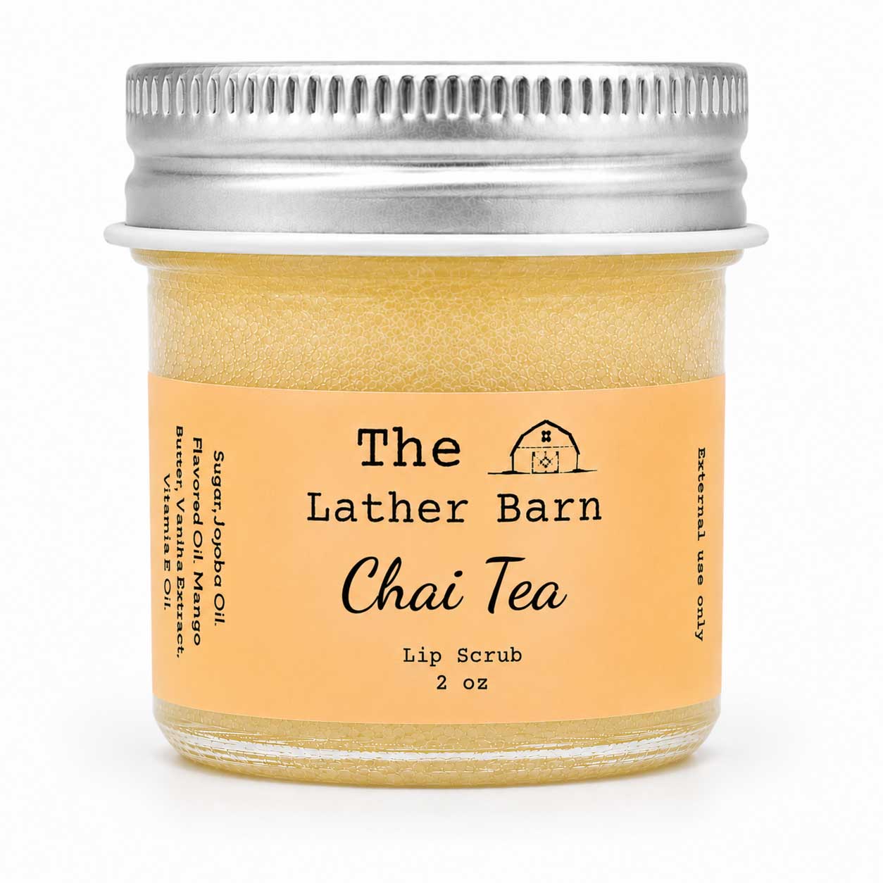A 2 oz glass jar of 'The Lather Barn Chai Tea Lip Scrub' with a light orange label and a silver metal screw-on lid, shown on a white background.