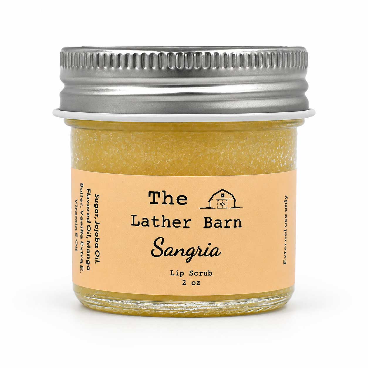 A 2 oz glass jar of 'The Lather Barn' Sangria Lip Scrub, filled with a yellowish-amber scrub and featuring a light peach label with a silver metal screw lid, set against a plain white background.
