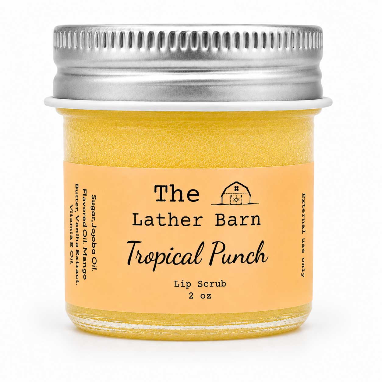 A 2 oz glass jar of The Lather Barn Tropical Punch Lip Scrub, filled with a yellow-orange scrub and featuring a peach-colored label with a silver metal screw cap, set against a plain white background.