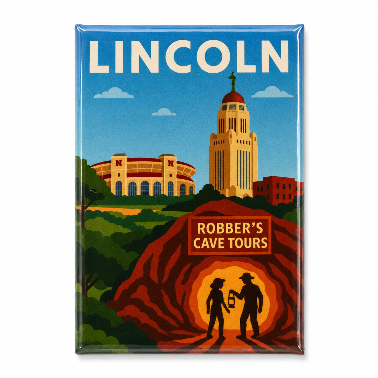 A rectangular travel-style poster or magnet featuring a retro illustration of Lincoln, Nebraska, with the word LINCOLN at the top, a blue sky, the University of Nebraska stadium, the University of Nebraska Tower, green trees, and two silhouetted cave explorers in front of a glowing cave entrance. The phrase 'ROBBER'S CAVE TOURS' appears on a sign in the lower right.