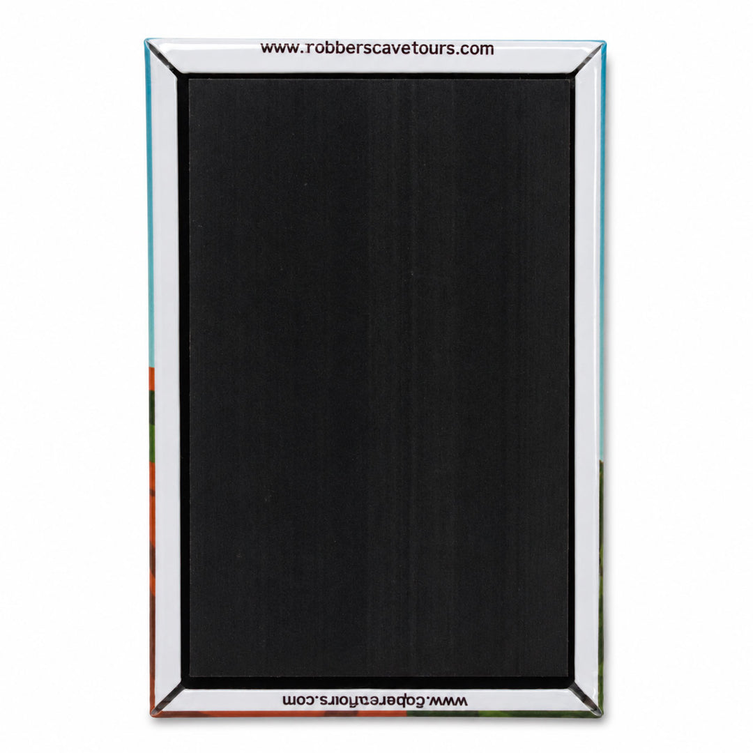 A rectangular black textured panel with a silver metallic frame, featuring website text at the top and bottom, shown against a plain white background.