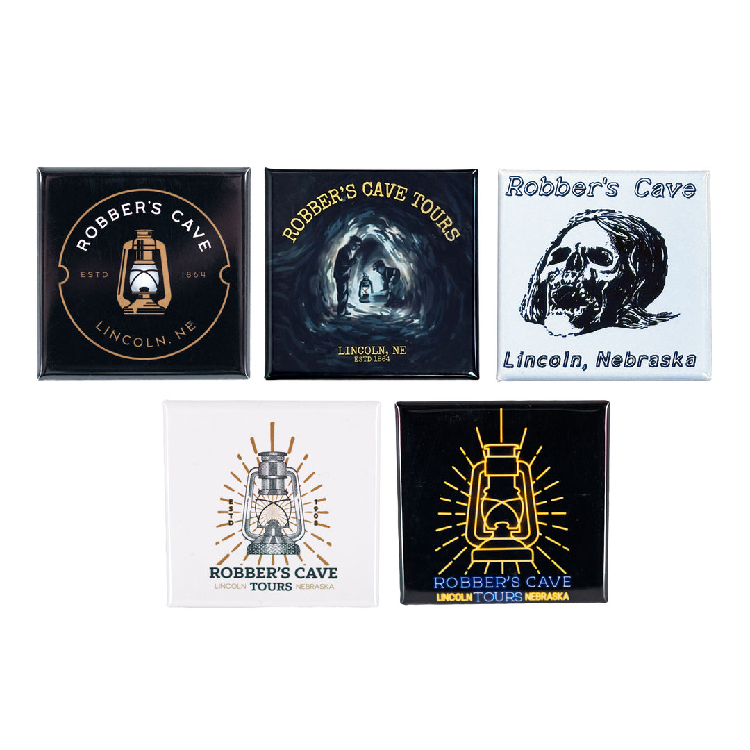 Set of five 'Robber's Cave' themed magnets on a white background