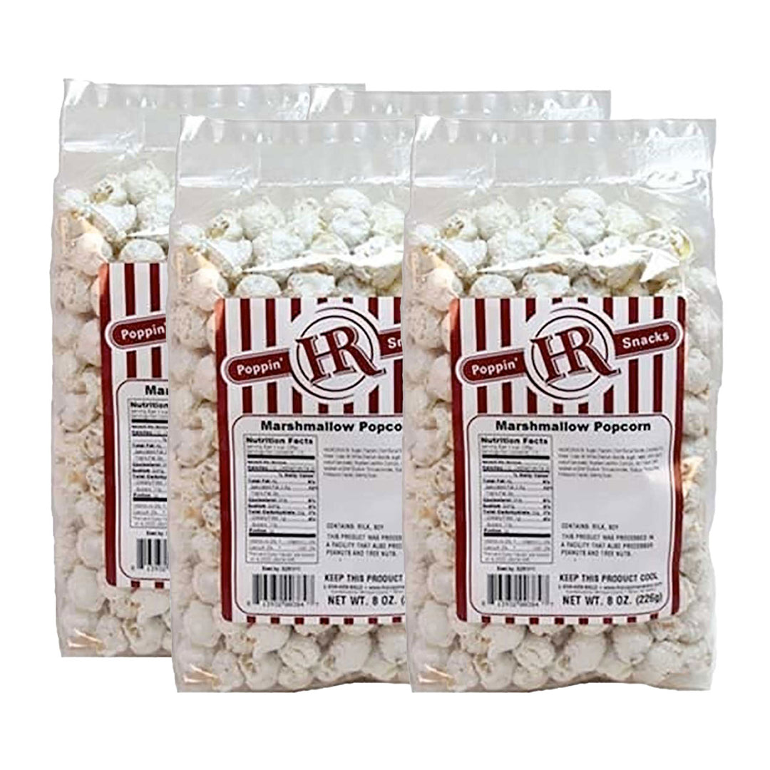 Four packages of marshmallow popcorn with Poppin' Hot label on a white background
