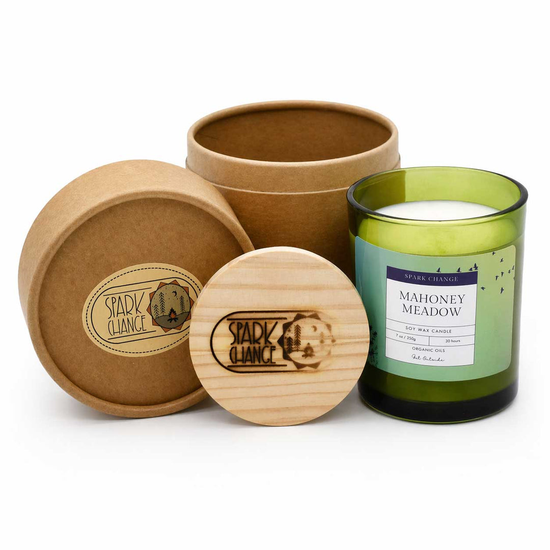 Green candle in a wooden container with a wooden lid on a white background