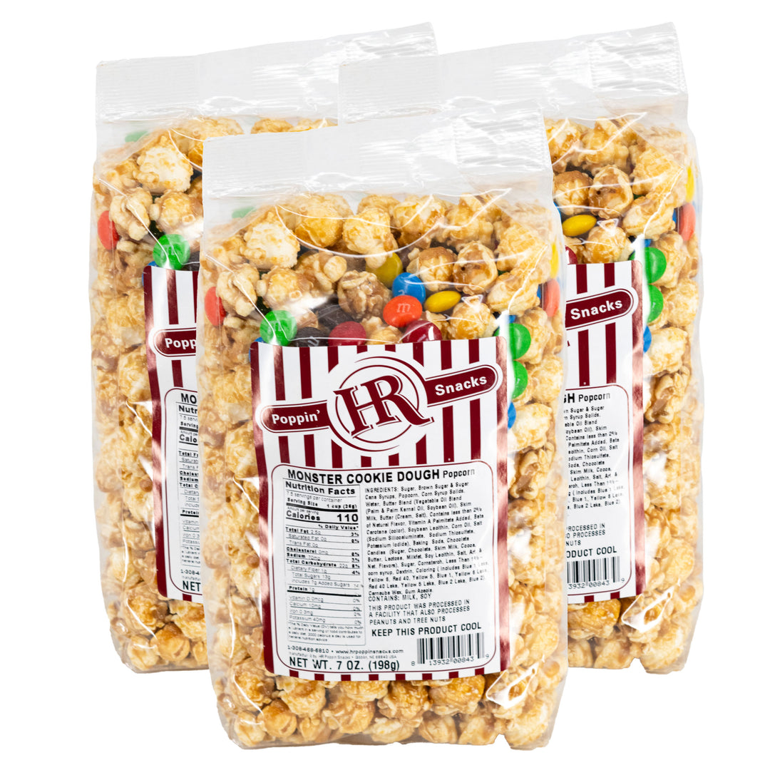 Three bags of HR Poppin' Snacks Monster Cookie Dough Popcorn on a white background