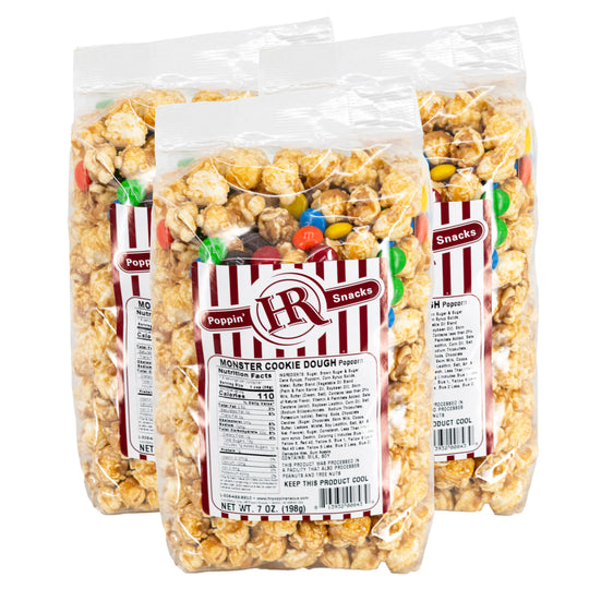Three bags of HR Poppin' Snacks Monster Cookie Dough Popcorn on a white background
