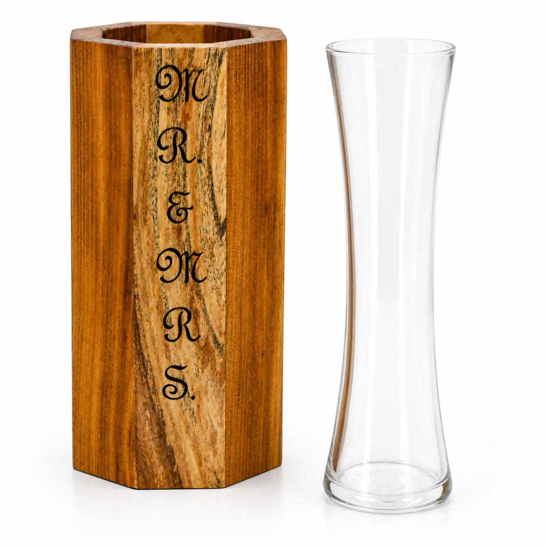 Wooden vase with engraved 'MR & MRS' next to a clear glass vase on a white background