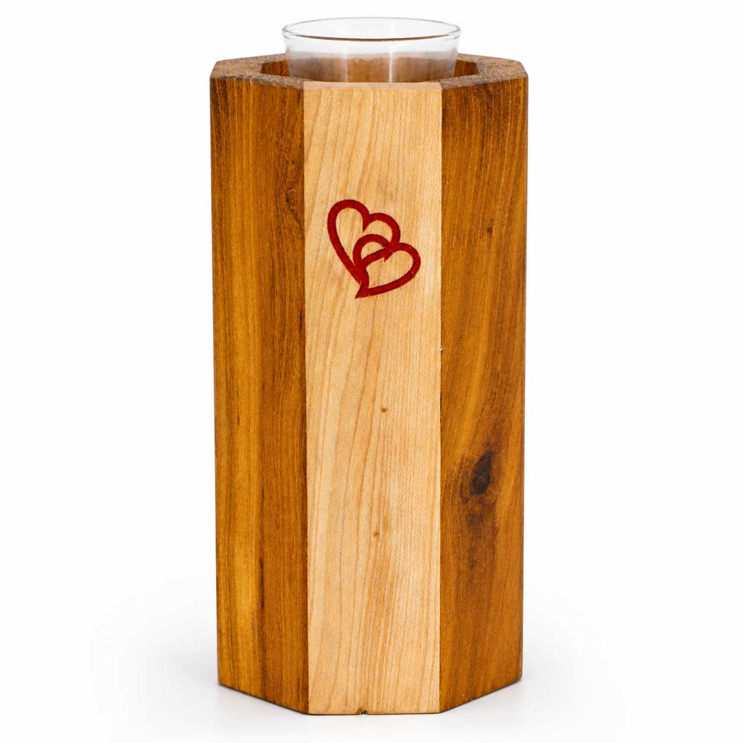 Wooden candle holder with a red heart design on a white background