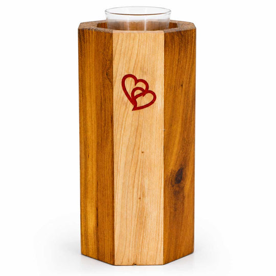 Wooden candle holder with a red heart design on a white background