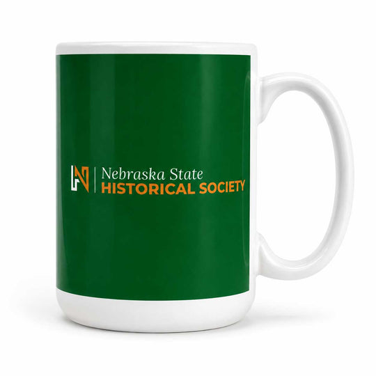 A white ceramic mug with a dark green wraparound print featuring the Nebraska State Historical Society logo and text.