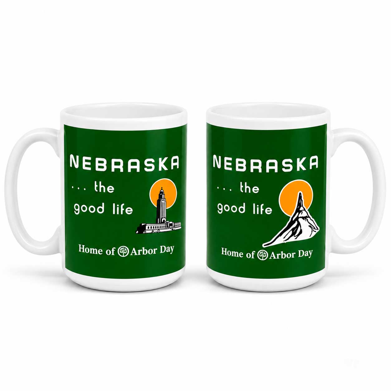 Two white ceramic mugs with a green Nebraska graphic design, shown side by side on a white background. The design features the text 'NEBRASKA .