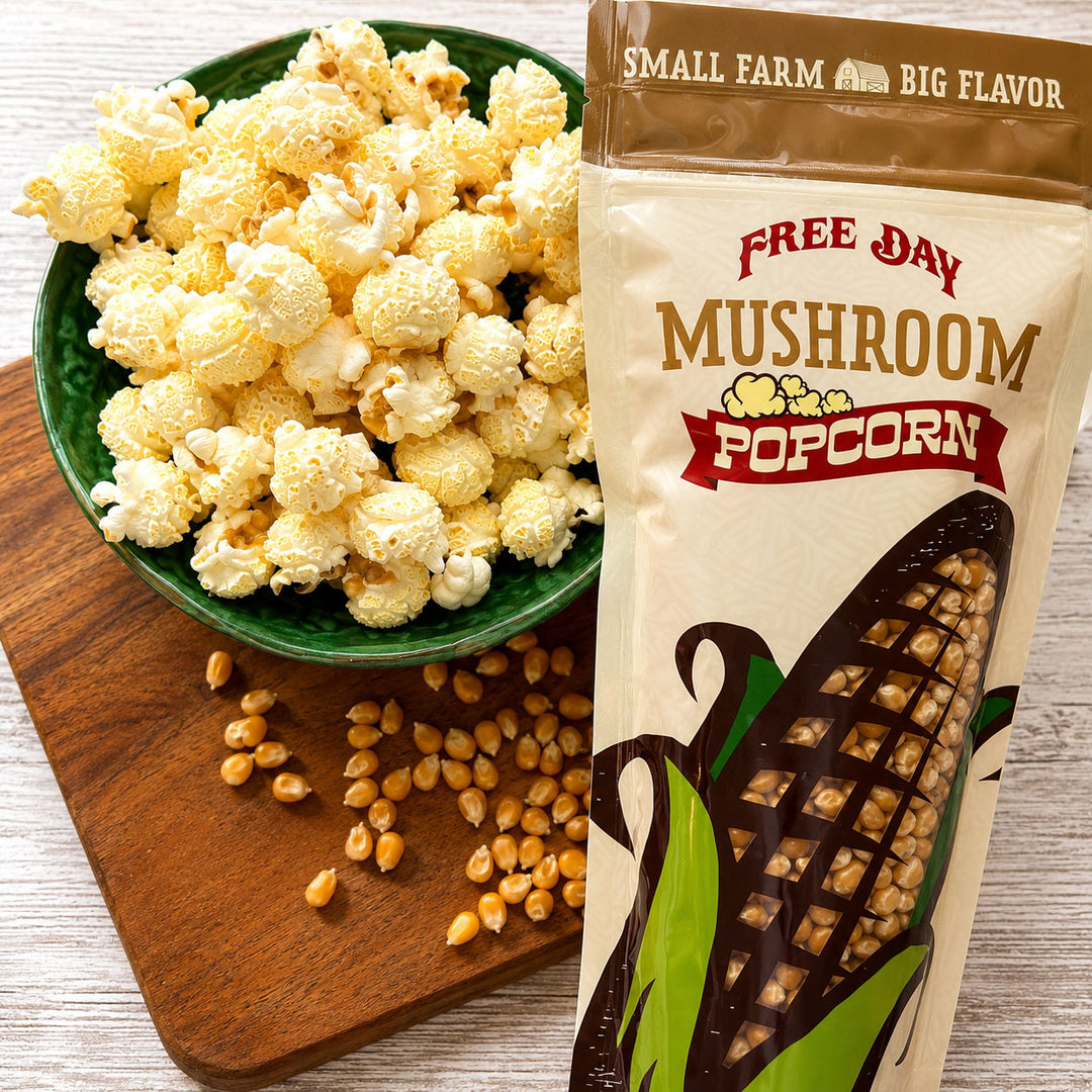 Mushroom popcorn in a bowl and on a wooden board with a Free Day Mushroom Popcorn package.
