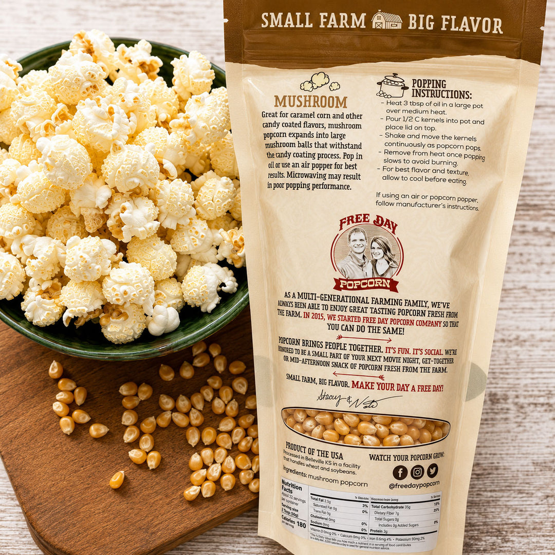 Mushroom popcorn package with a bowl of popcorn and kernels on a wooden board.