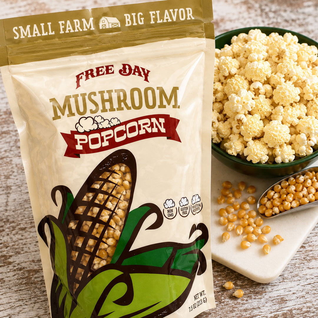 Free Day Mushroom Popcorn package with popcorn and kernels on a wooden surface