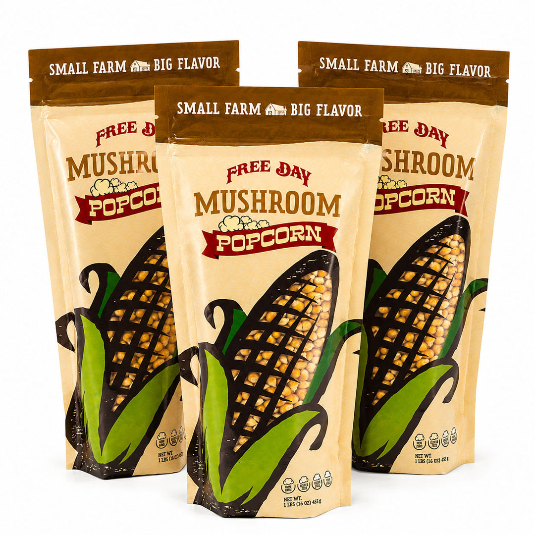 Three packages of Free Day Mushroom Popcorn on a white background