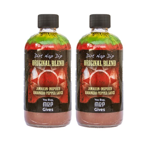 Two bottles of 'Dirt Nap Dip Original Blend' Jamaican-inspired habanero pepper sauce on a white background.