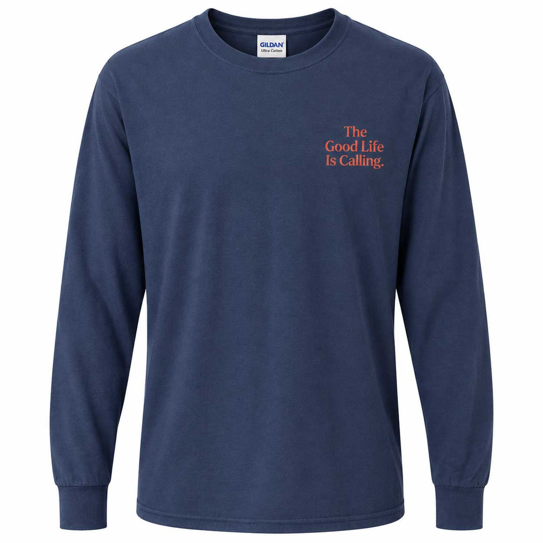 A navy blue long-sleeve t-shirt with orange text on the left chest reading 'The Good Life Is Calling.' The shirt is shown on a plain white background, with a Gildan brand tag visible inside the collar.