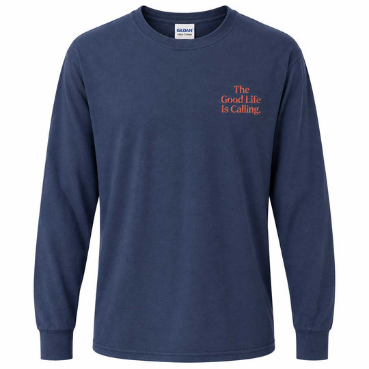 A navy blue long-sleeve t-shirt with orange text on the left chest reading 'The Good Life Is Calling.' The shirt is shown on a plain white background, with a Gildan brand tag visible inside the collar.