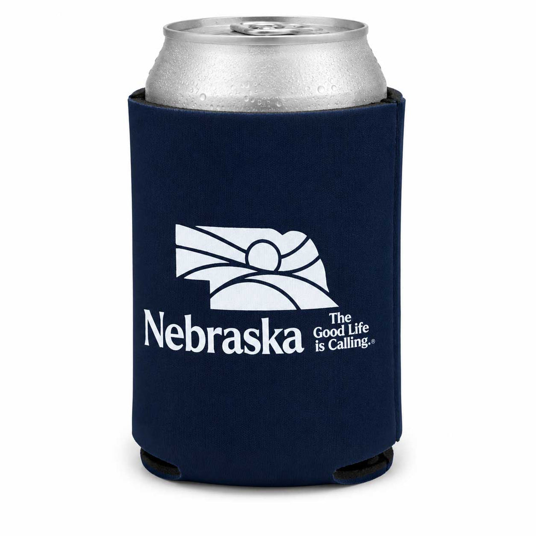A navy blue neoprene can cooler sleeve with a silver aluminum can inserted, featuring the white Nebraska state outline and the text 'Nebraska The Good Life Is Calling.
