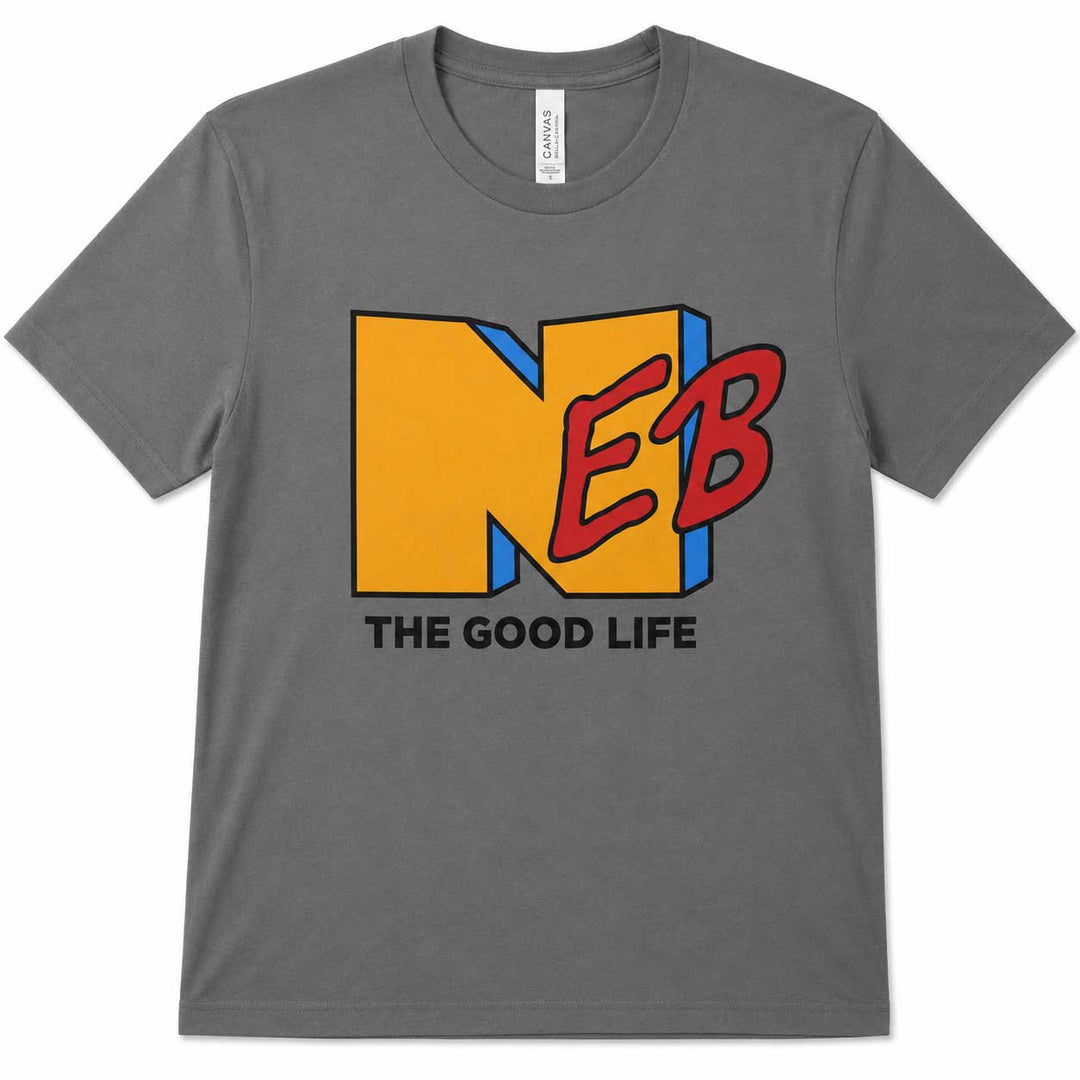 A dark gray crewneck t-shirt featuring a graphic print of the letters 'N', 'E', and 'B' in yellow, red, and blue, with the text 'THE GOOD LIFE' printed below in black.
