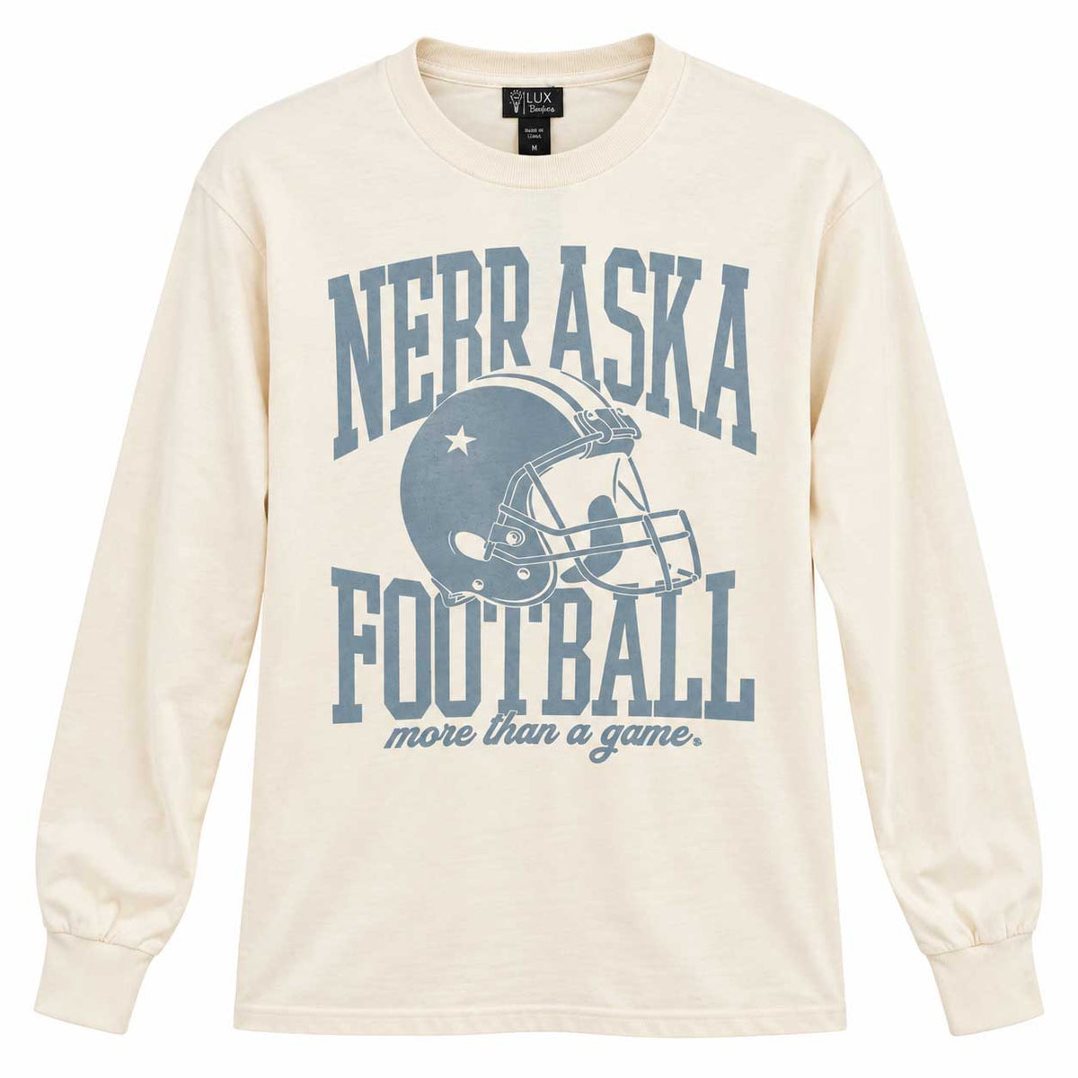 An off-white long-sleeve t-shirt with a blue graphic print reading 'NEBRASKA FOOTBALL more than a game.' and featuring a football helmet illustration, shown against a plain white background.