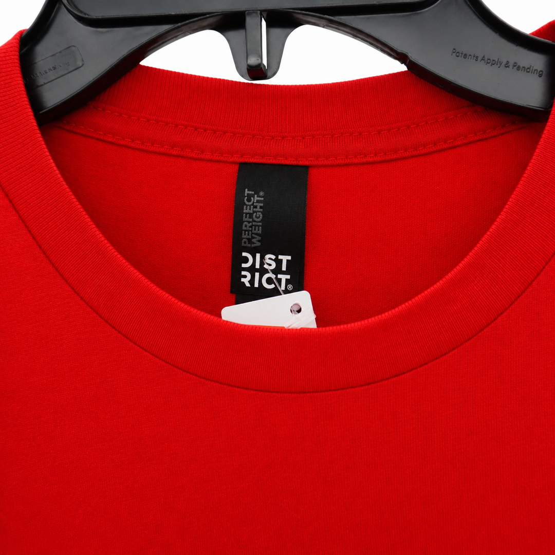 Red t-shirt with a label on a white background