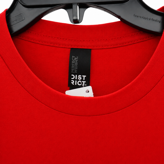 Red t-shirt with a label on a white background