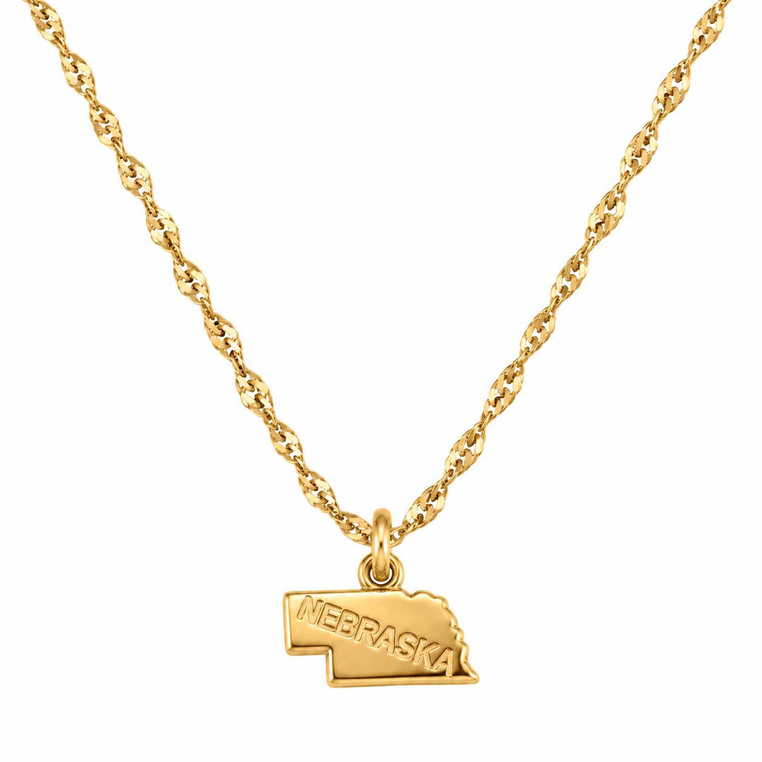 A gold necklace featuring a twisted chain and a small pendant shaped like the state of Nebraska, with the word 'NEBRASKA' engraved on the front, shown against a plain white background.