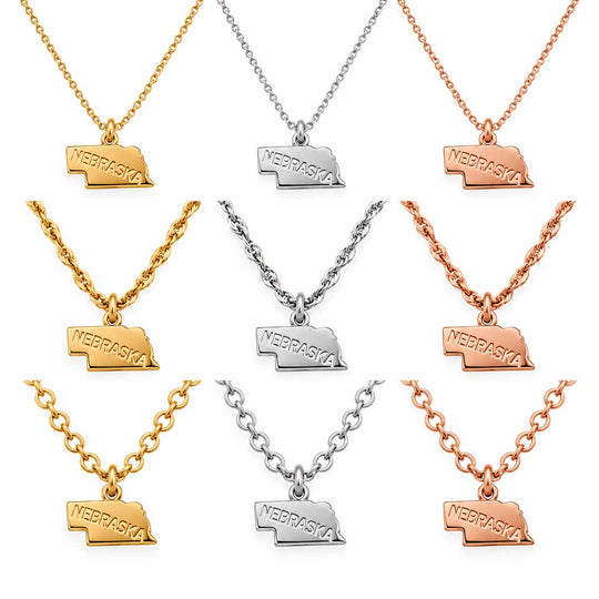 Nine Nebraska-shaped pendant necklaces arranged in a 3x3 grid on a white background, shown in yellow gold, silver, and rose gold finishes.
