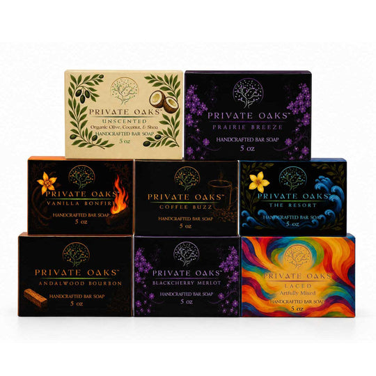 Nine boxes of Private Oaks handcrafted bar soap arranged in a pyramid on a white background. The boxes feature various colorful and patterned designs including green leaves, purple flowers, flames, and abstract swirls.