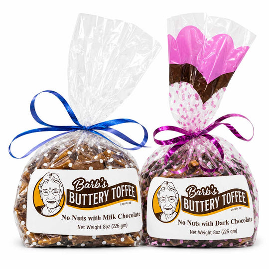 Two bags of Barb's Buttery Toffee, one with milk chocolate and one with dark chocolate, wrapped in clear cellophane with blue and purple ribbons and displayed on a white background.