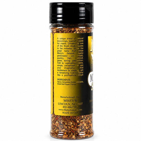 Spice jar with black lid and yellow label on a white background