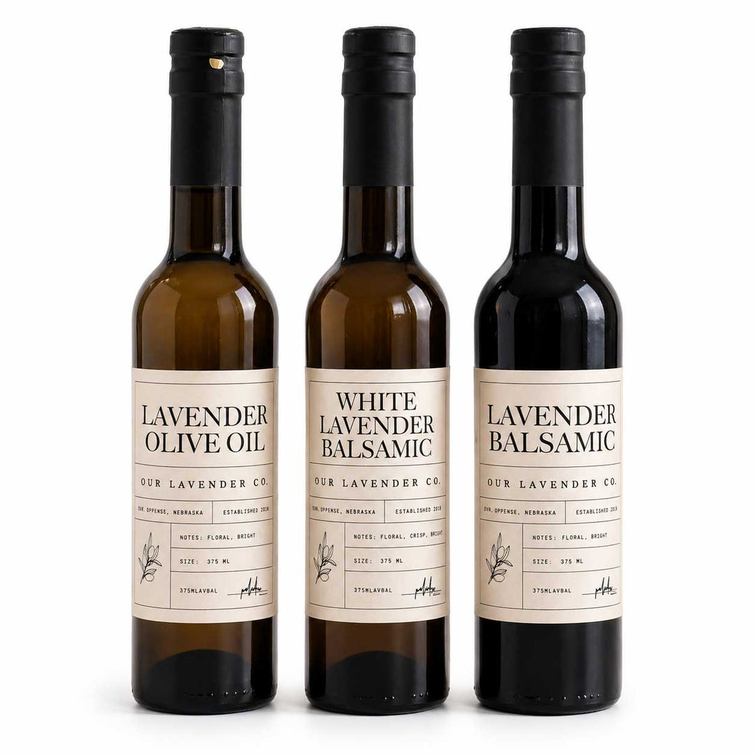 Three bottles of lavender-infused olive oil and balsamic vinegar on a white background