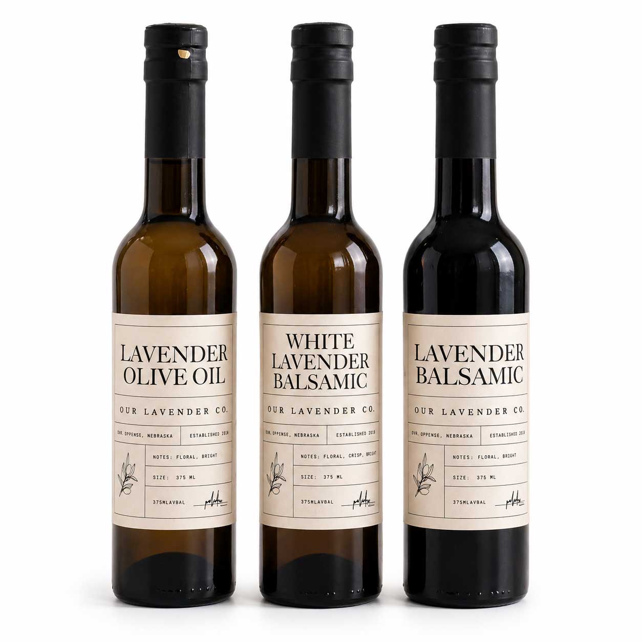 Three bottles of lavender-infused olive oil and balsamic vinegar on a white background