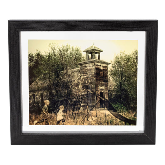 Photo of old school house with children playing.