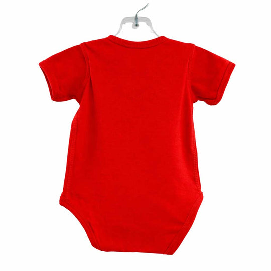 Red baby onesie on a white background