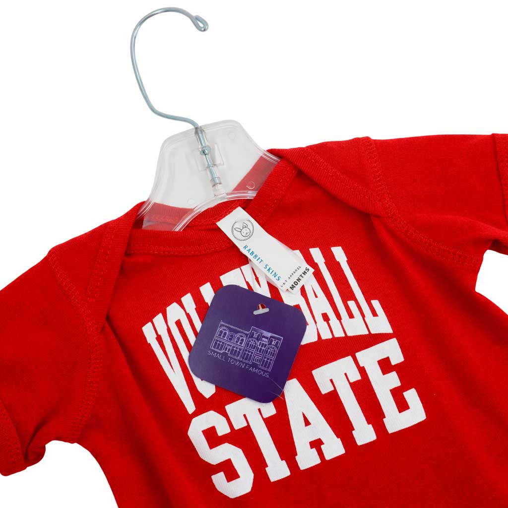 Red baby onesie with 'VOLUNTEER ALL STATE' text on a hanger.