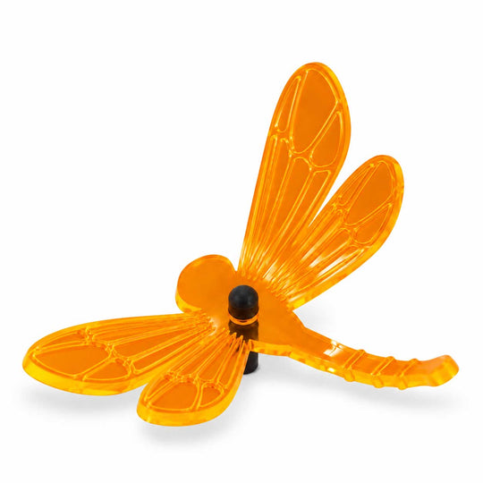 A translucent neon orange dragonfly-shaped wind spinner with a black central hub and support post, shown on a clean white background.