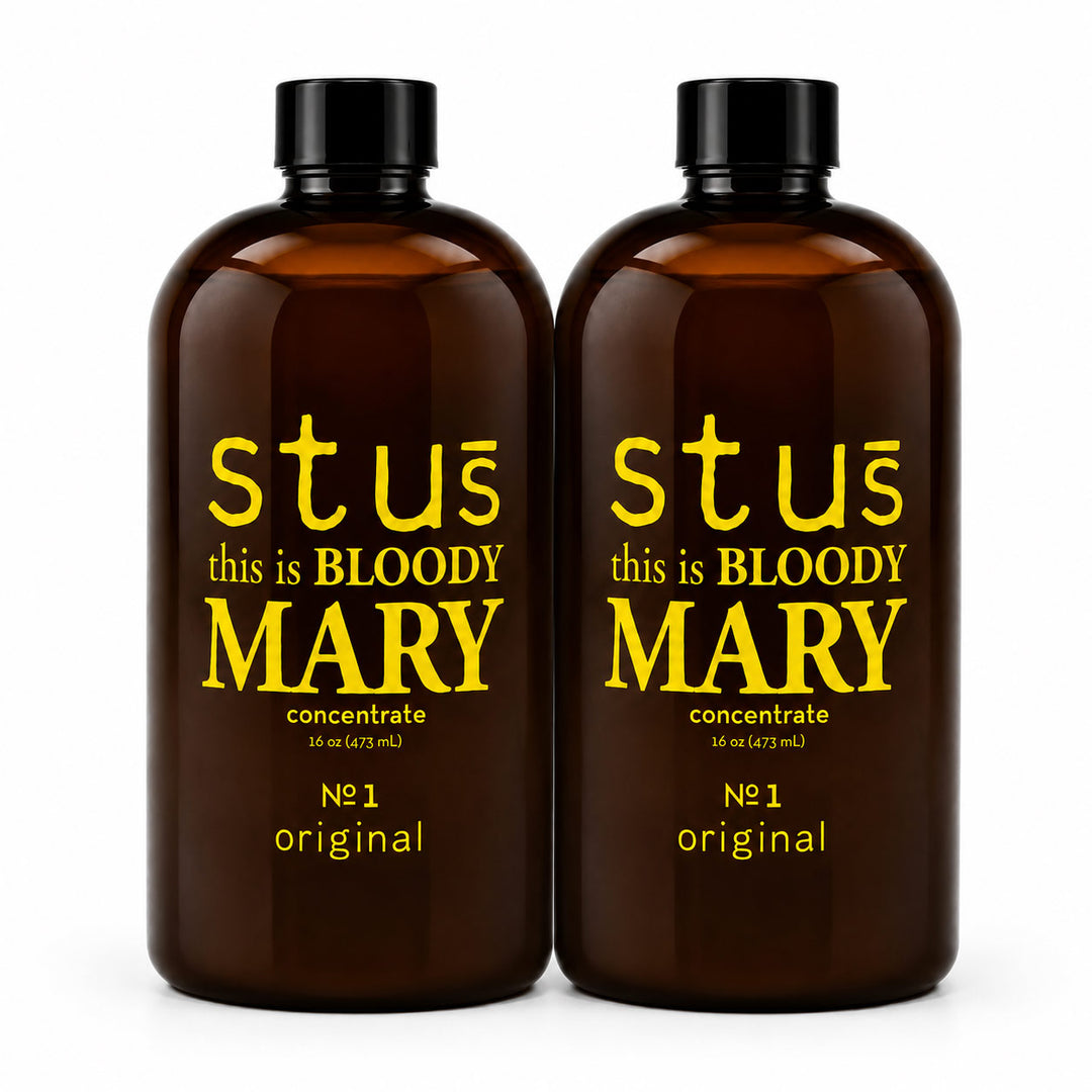 Two amber glass bottles with black caps, featuring yellow text that reads 'stus this is BLOODY MARY' and 'concentrate' on a white background.